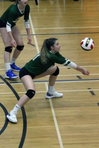 A girl preparing to hit a falling volleyball